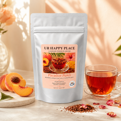 Paradise Peach Rooibos loose leaf tea pouch displayed with a glass cup of tea, fresh peaches, rose petals, and loose rooibos leaves.