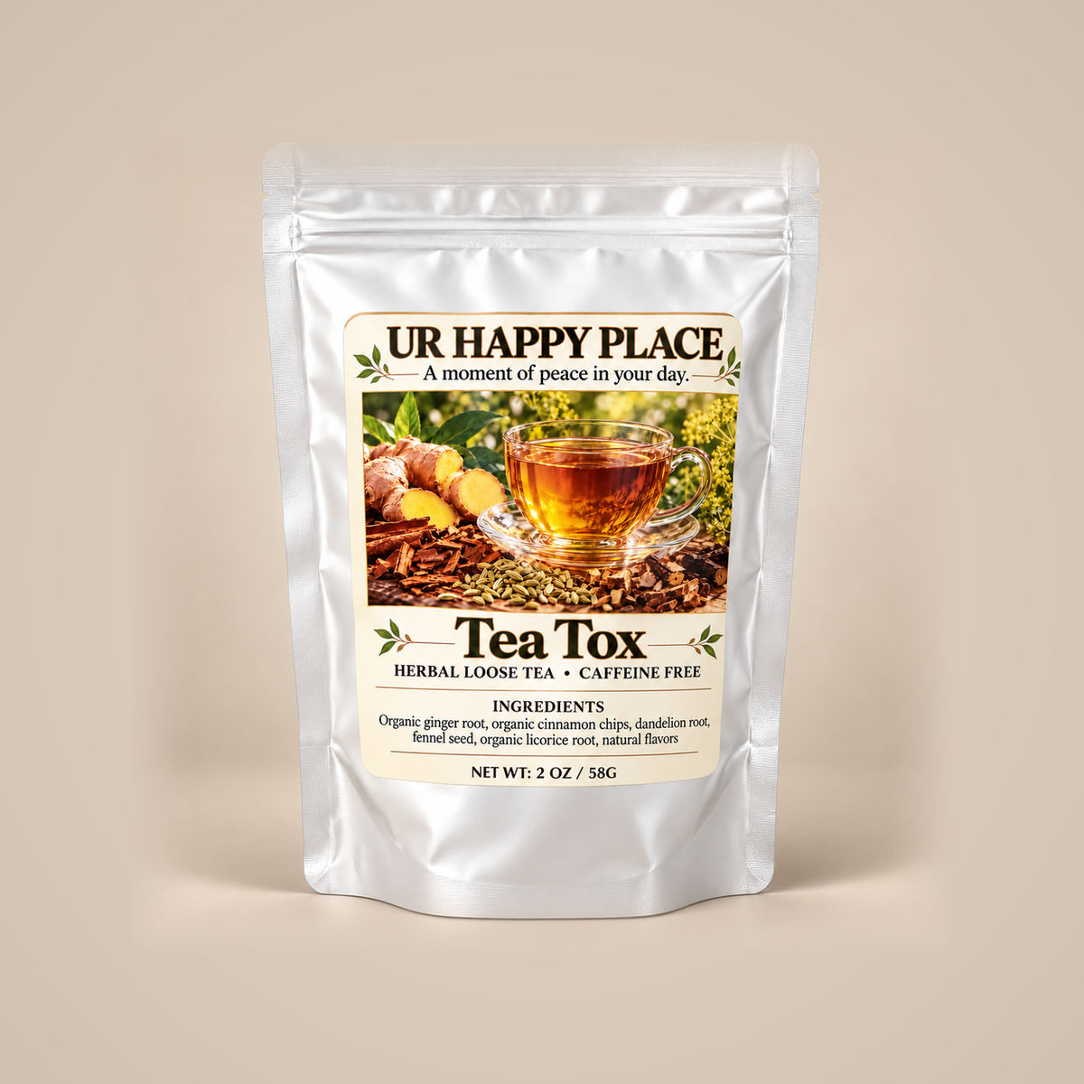 A silver stand-up pouch of 'UR HAPPY PLACE Tea Tox' herbal loose tea, displayed against a solid beige background. The front label features a central image of a glass cup of tea surrounded by ginger and herbs, with text detailing the caffeine-free ingredients.